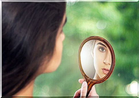 Woman looking into a mirror