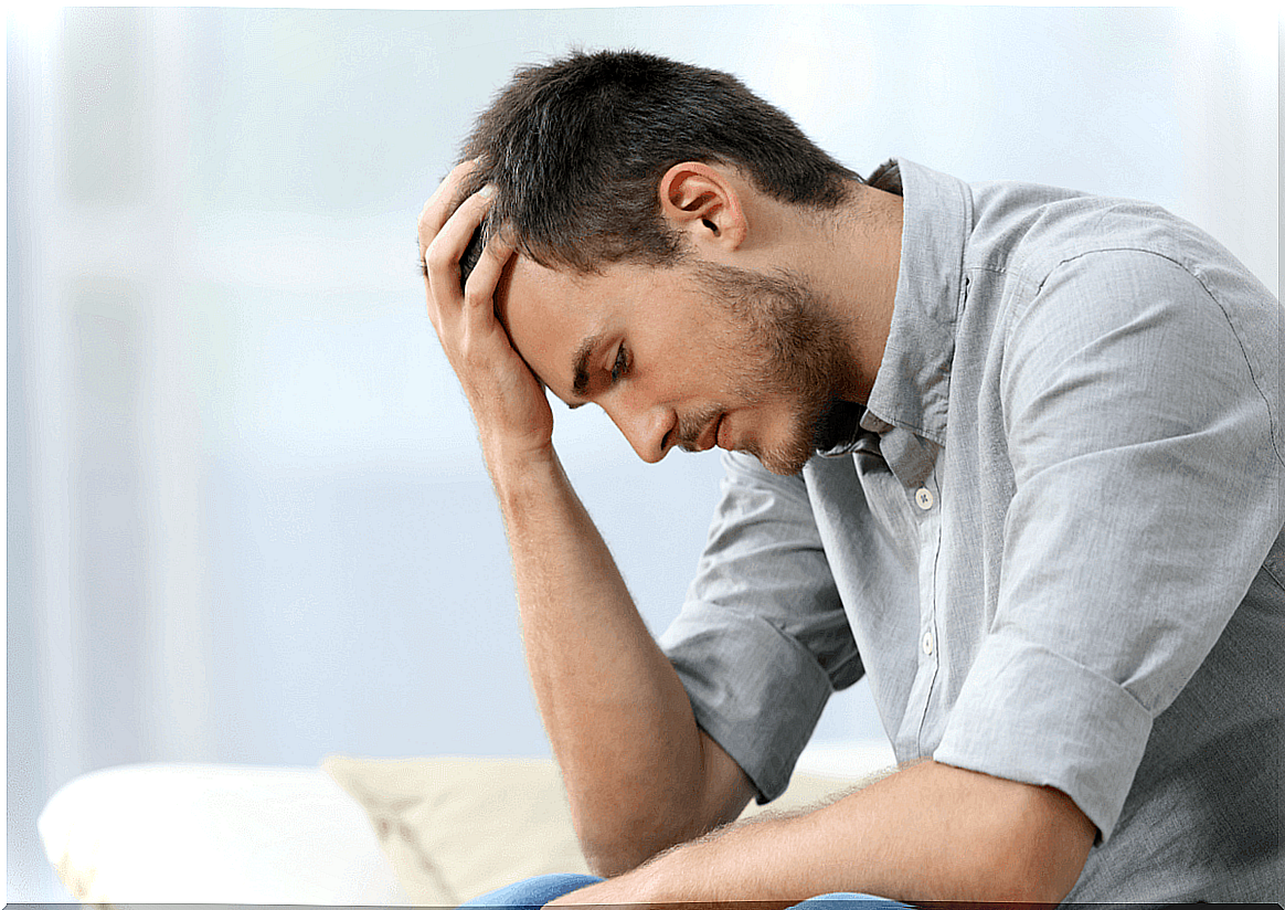 Boy resting head on hand suffering from anxiety and blurred vision