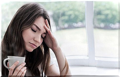 Anxious woman having tea