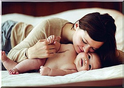 Mother kissing her son with attachment