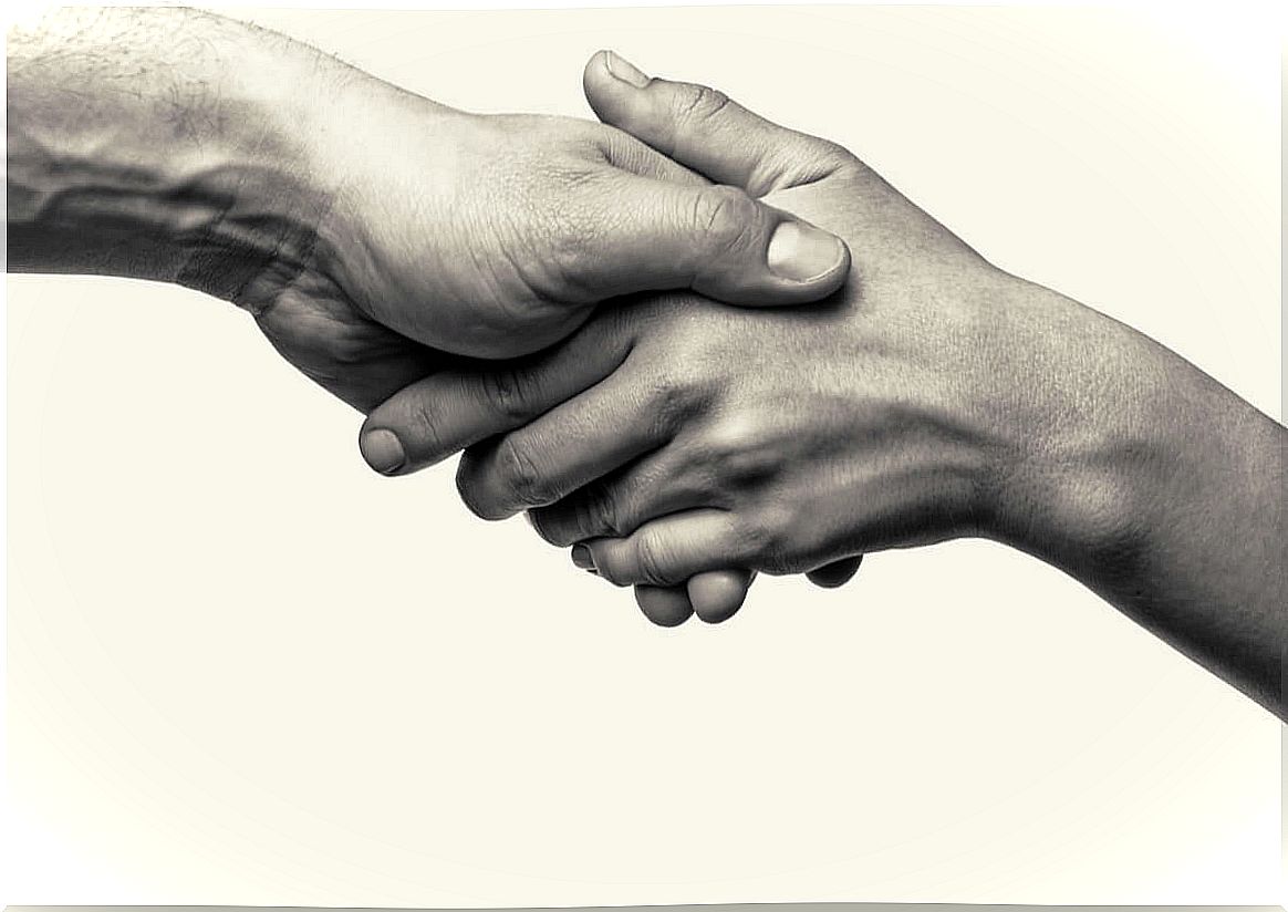 Hands of two people holding each other