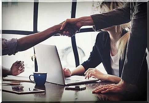 Man shaking hands with another to negotiate