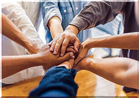 Group of people putting their hands together to represent social entrepreneurship