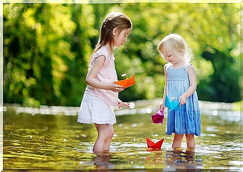 Children sharing paper boats