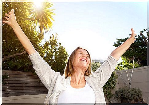 Senior woman with open arms and smiling