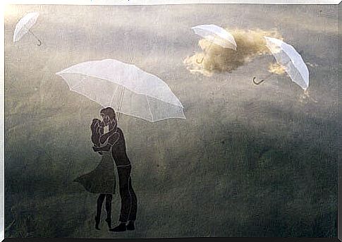 Couple kissing under an umbrella