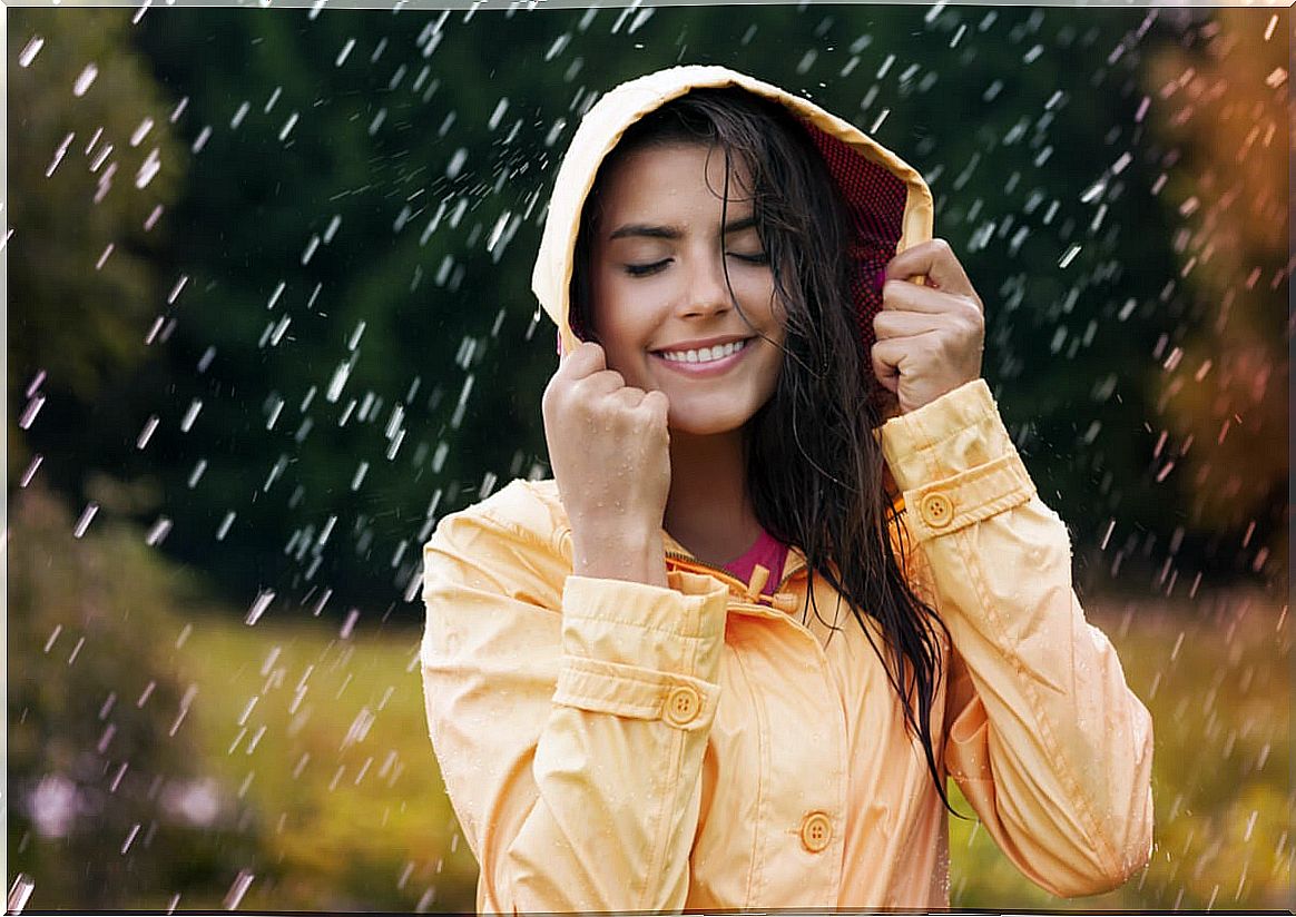 Woman smiling while raining