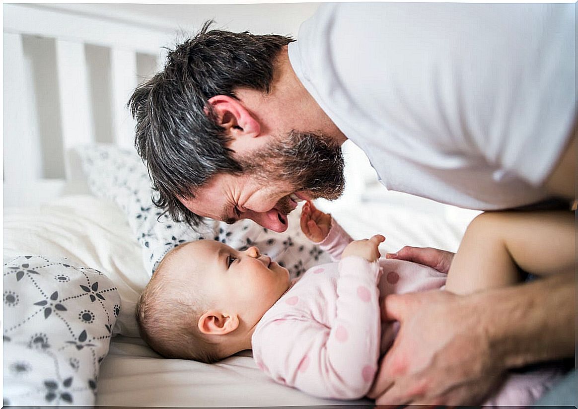 Father talking to his baby avoiding parental burnout