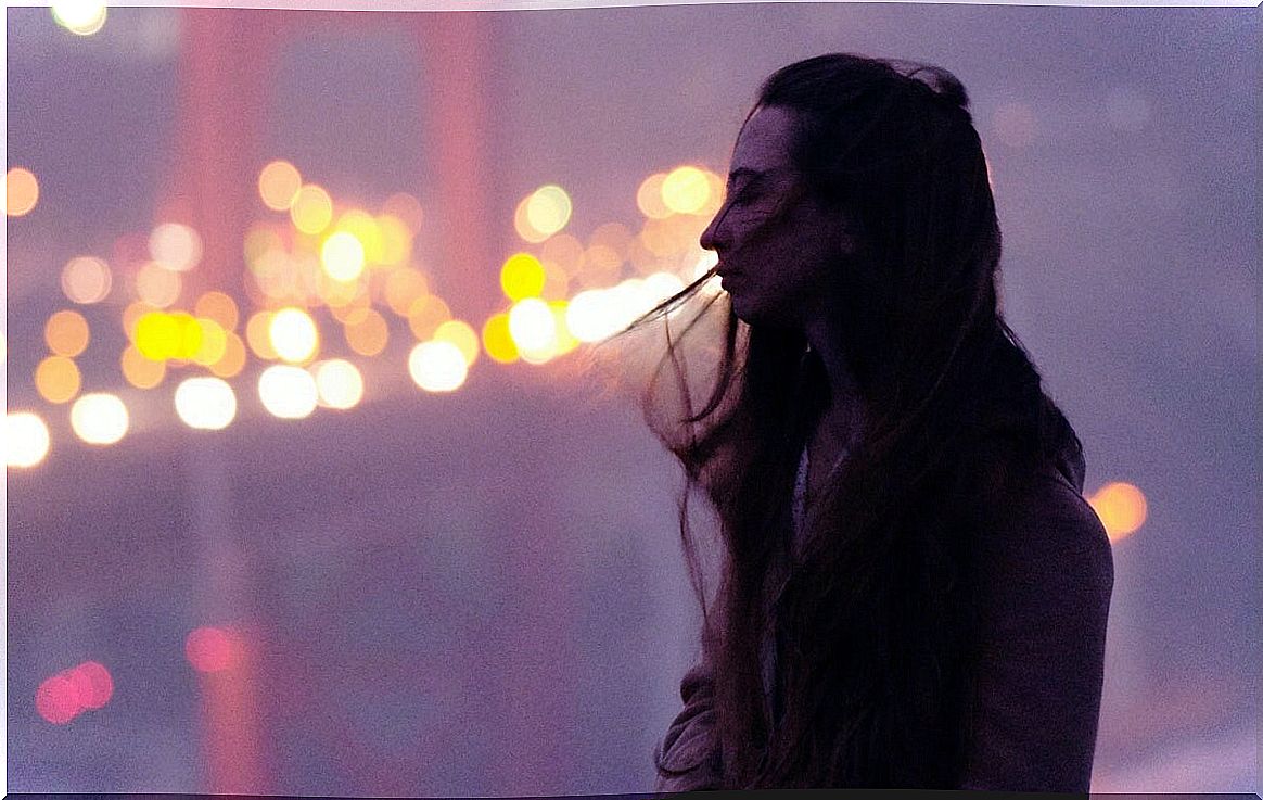 Girl alone on a bridge thinking about positive reaffirmation