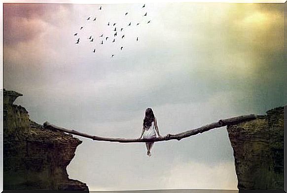 woman sitting on a log and suspended in an abyss thinking about what she should do