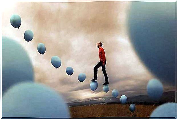 man climbing a ladder made of balloons