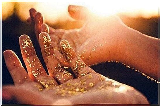 hands with gold dust representing the meaning of life according to Viktor Frankl