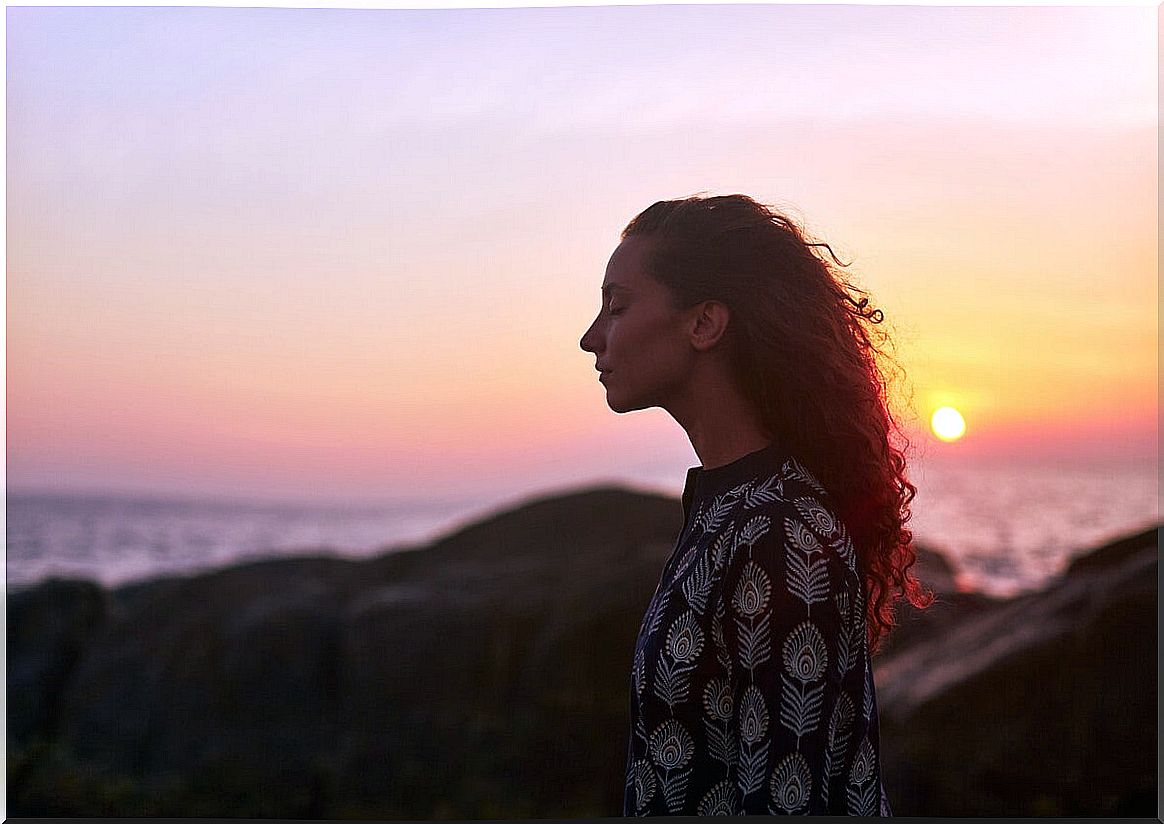 Woman eyes closed at sunset