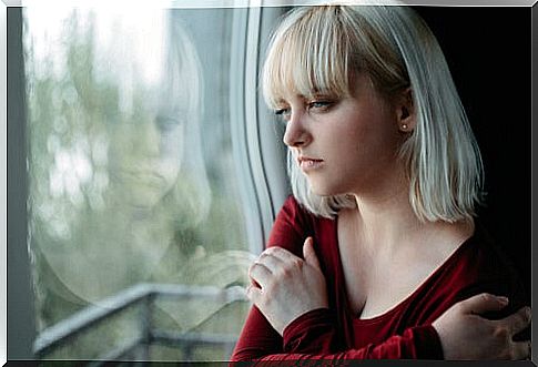 Woman with schizophrenia looking out the window