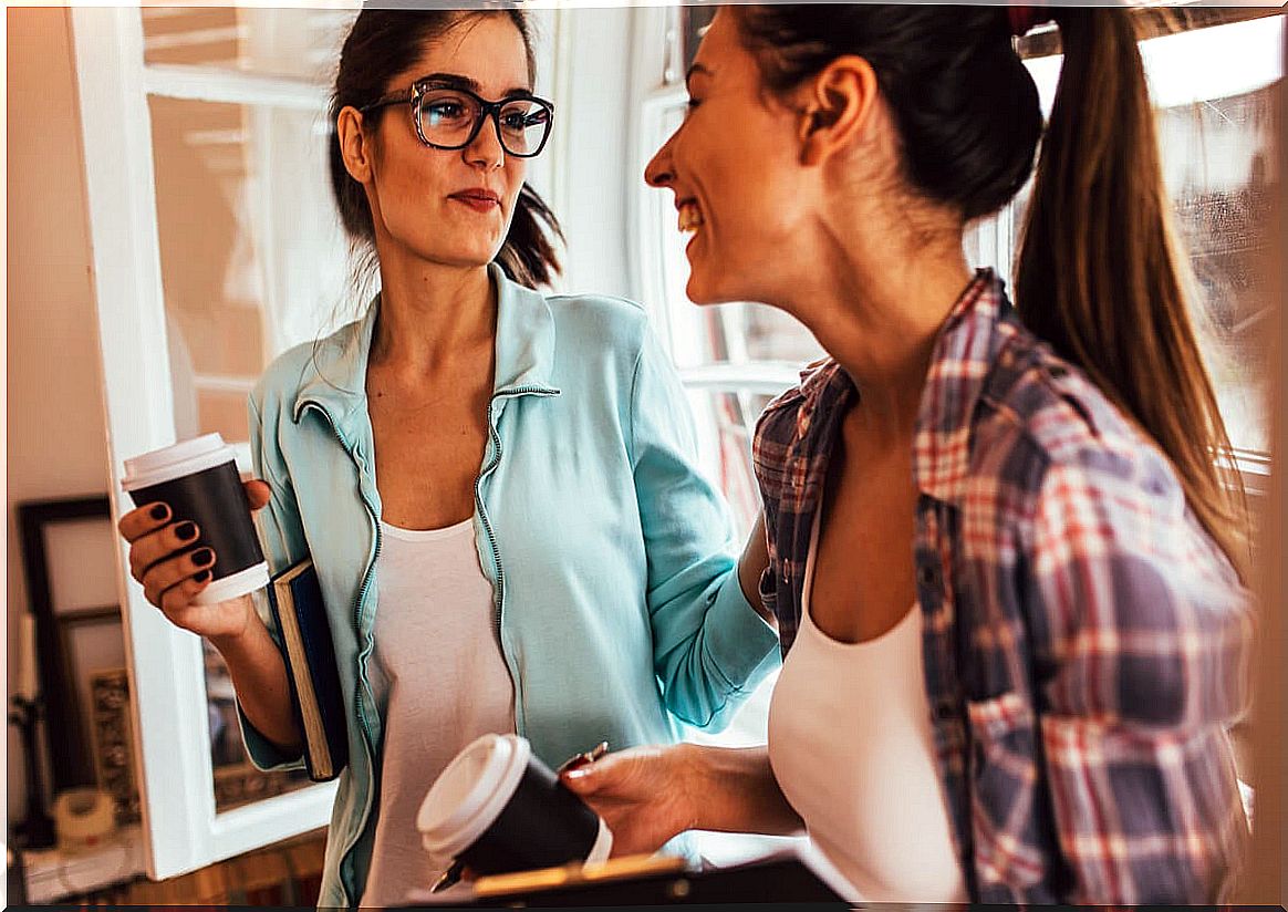 Girlfriends talking while having coffee