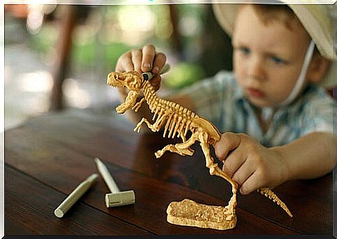 Boy playing with a dinosaur