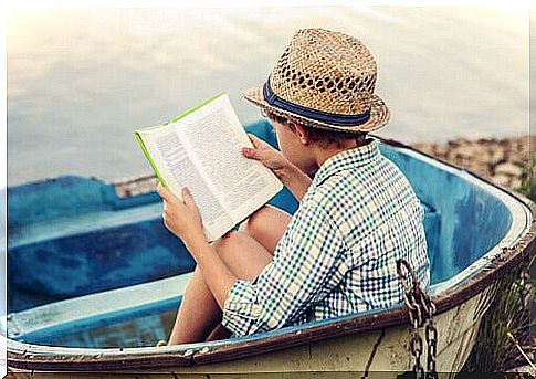 Boy reading on the beach